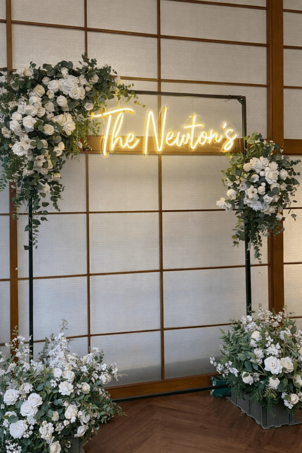 “The Newtons” custom neon sign in LED light on a round mesh backdrop